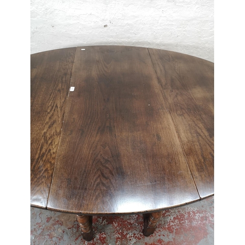 1137 - An 18th century style solid English oak drop leaf gate leg dining table with single drawer - approx.... 