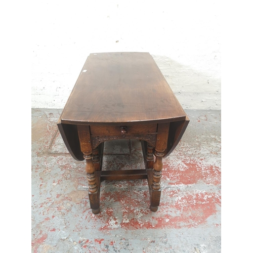 1137 - An 18th century style solid English oak drop leaf gate leg dining table with single drawer - approx.... 