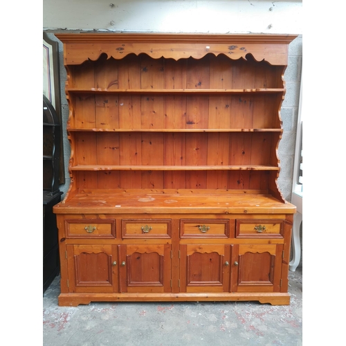 1140 - A 19th century style solid pine Welsh dresser with upper three tier plate rack, four drawers and fou... 