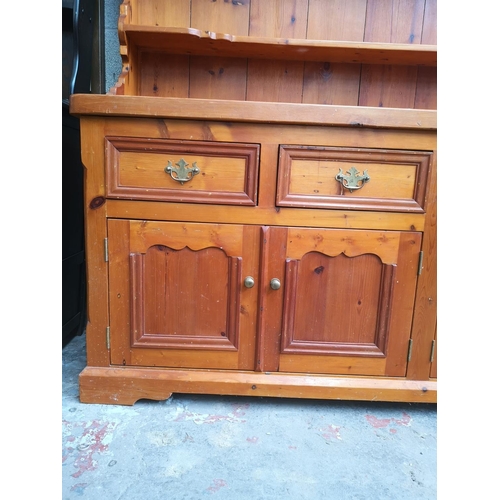 1140 - A 19th century style solid pine Welsh dresser with upper three tier plate rack, four drawers and fou... 