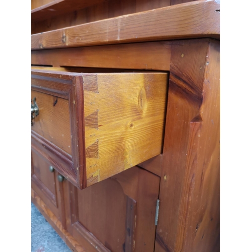 1140 - A 19th century style solid pine Welsh dresser with upper three tier plate rack, four drawers and fou... 