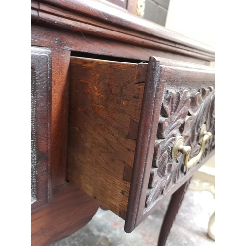 1147 - A late 19th/early 20th century carved oak dresser with two cupboard doors, upper plate rack, three d... 