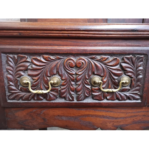 1147 - A late 19th/early 20th century carved oak dresser with two cupboard doors, upper plate rack, three d... 