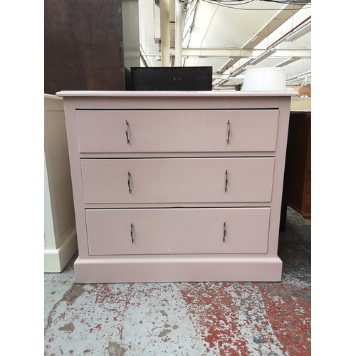 1151 - A mid 20th century pink painted chest of three drawers - approx. 81cm high x 90cm wide x 45cm deep