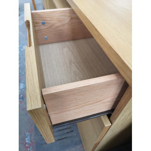 1098 - A modern oak effect office desk with three drawers and pull out tray - approx. 74.5cm high x 120cm w... 