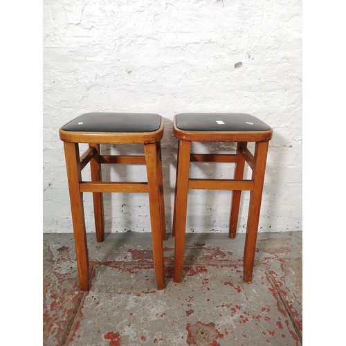 1097 - Four pieces of mid 20th century furniture, two beech and black vinyl stools - approx. 62cm x 33cm² a... 