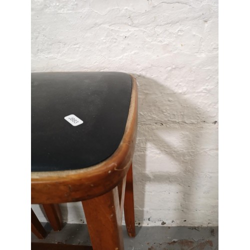 1097 - Four pieces of mid 20th century furniture, two beech and black vinyl stools - approx. 62cm x 33cm² a... 