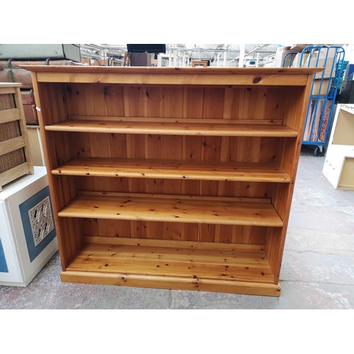 1095B - A modern pine four tier open bookcase - approx. 138cm high x 151cm wide x 39.5cm deep