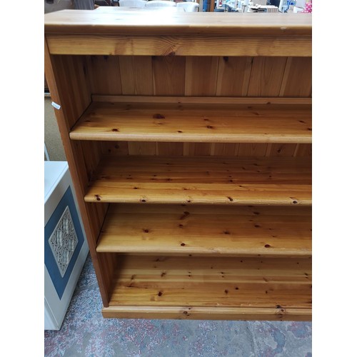 1095B - A modern pine four tier open bookcase - approx. 138cm high x 151cm wide x 39.5cm deep