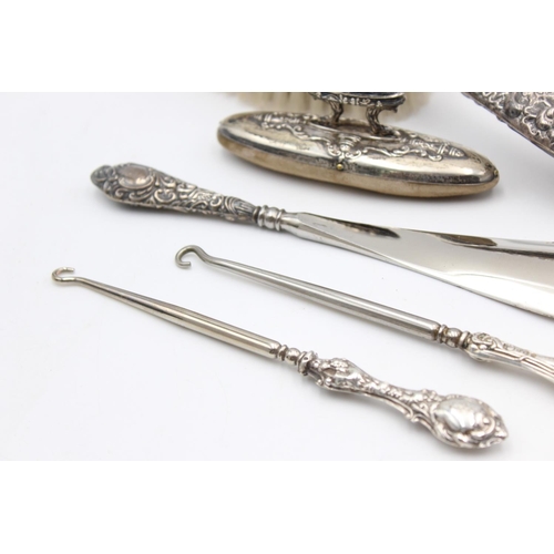 224 - Eight antique hallmarked .925 sterling silver ladies vanity items to include brushes, handled tools,... 