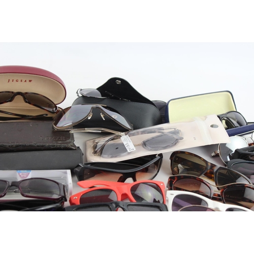 714 - A large collection of assorted sunglasses to include Calvin Klein, Lipsy London, Fabris Lane etc.