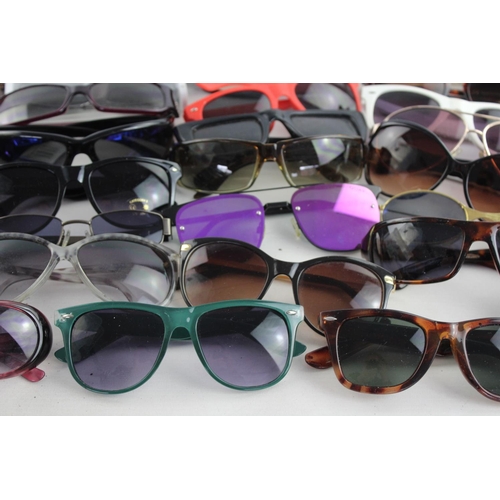 714 - A large collection of assorted sunglasses to include Calvin Klein, Lipsy London, Fabris Lane etc.