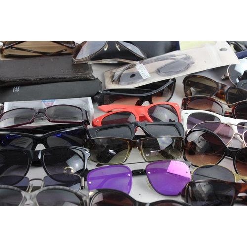 714 - A large collection of assorted sunglasses to include Calvin Klein, Lipsy London, Fabris Lane etc.