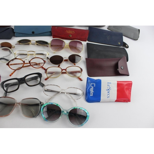 715 - A collection of assorted pairs of vintage sunglasses and spectacles to include Polaroid, 70's etc.