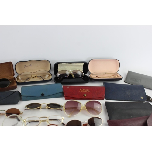 715 - A collection of assorted pairs of vintage sunglasses and spectacles to include Polaroid, 70's etc.