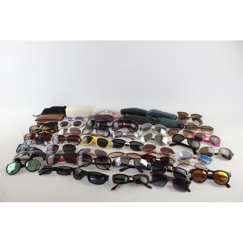 717 - A large collection of assorted pairs of sunglasses to include DKNY, Foster Gant, Oasis etc.