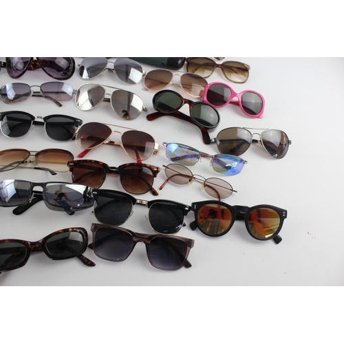 717 - A large collection of assorted pairs of sunglasses to include DKNY, Foster Gant, Oasis etc.