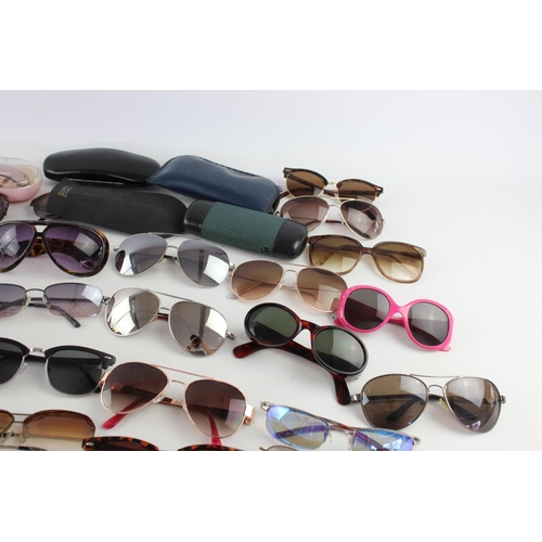 717 - A large collection of assorted pairs of sunglasses to include DKNY, Foster Gant, Oasis etc.