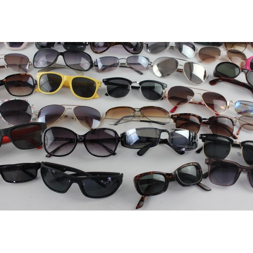 717 - A large collection of assorted pairs of sunglasses to include DKNY, Foster Gant, Oasis etc.