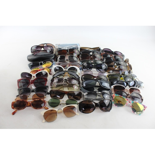 718 - A large collection of assorted sunglasses to include Storm, Firetrap, Maxmara etc.