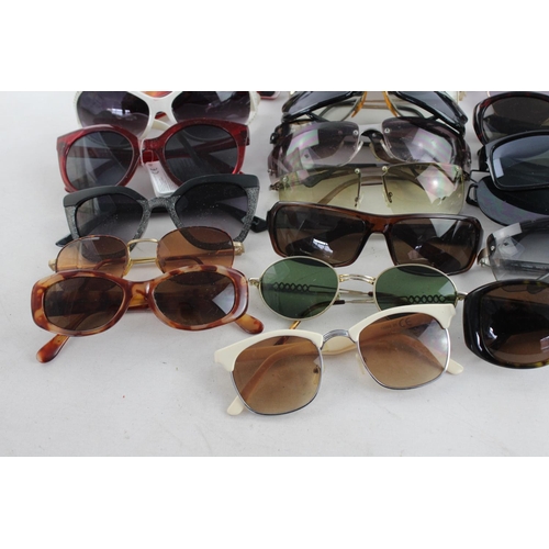 718 - A large collection of assorted sunglasses to include Storm, Firetrap, Maxmara etc.