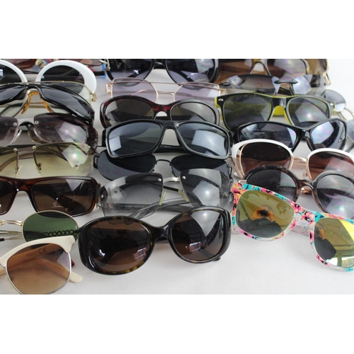 718 - A large collection of assorted sunglasses to include Storm, Firetrap, Maxmara etc.