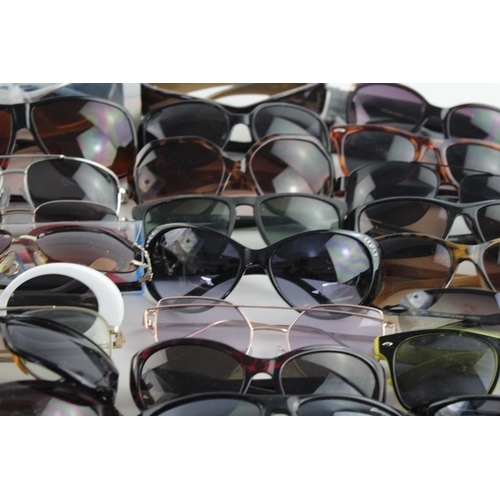 718 - A large collection of assorted sunglasses to include Storm, Firetrap, Maxmara etc.