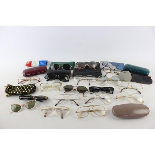 719 - A collection of assorted pairs of vintage sunglasses and spectacles to include Polaroid, 70's etc.