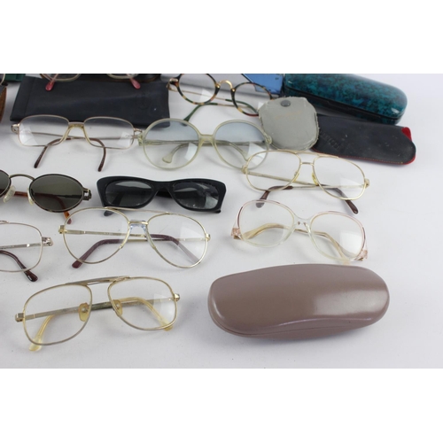 719 - A collection of assorted pairs of vintage sunglasses and spectacles to include Polaroid, 70's etc.