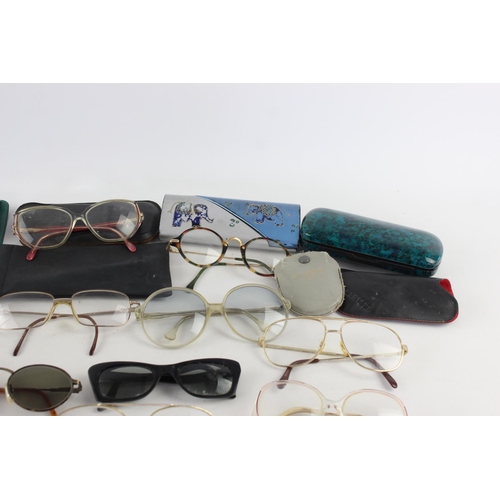 719 - A collection of assorted pairs of vintage sunglasses and spectacles to include Polaroid, 70's etc.