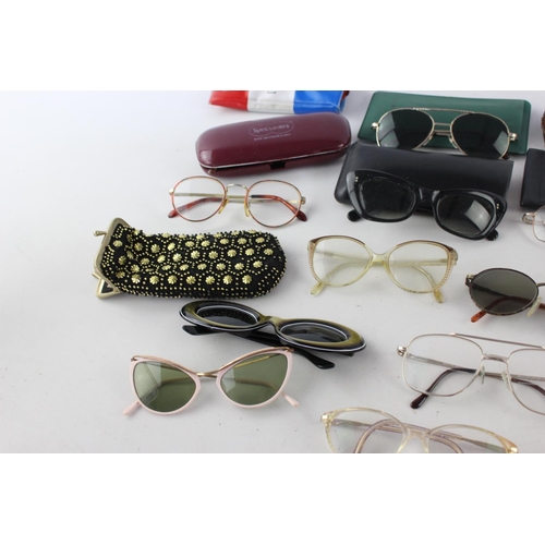 719 - A collection of assorted pairs of vintage sunglasses and spectacles to include Polaroid, 70's etc.