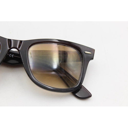 734 - A cased pair of classic Ray-Ban Wayfarer black framed sunglasses