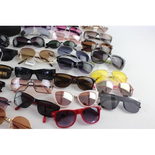 740 - A large collection of assorted pairs of sunglasses to include Bloc, Storm, Oakley etc.