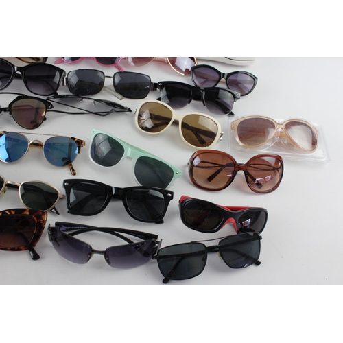 754 - A large collection of assorted pairs of sunglasses to include DKNY, Ted Baker, Nine West etc.