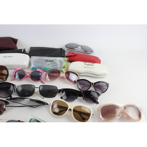 754 - A large collection of assorted pairs of sunglasses to include DKNY, Ted Baker, Nine West etc.