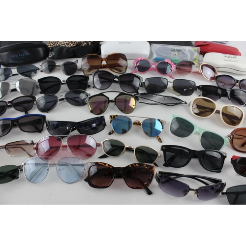 754 - A large collection of assorted pairs of sunglasses to include DKNY, Ted Baker, Nine West etc.