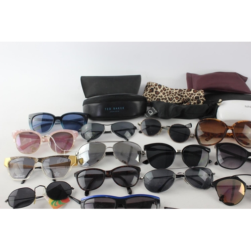 754 - A large collection of assorted pairs of sunglasses to include DKNY, Ted Baker, Nine West etc.