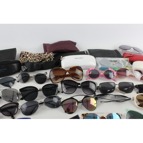 754 - A large collection of assorted pairs of sunglasses to include DKNY, Ted Baker, Nine West etc.