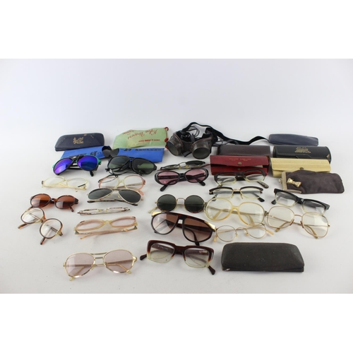 756 - A collection of assorted pairs of vintage sunglasses and spectacles to include Polaroid, 70's etc.