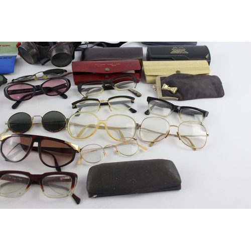 756 - A collection of assorted pairs of vintage sunglasses and spectacles to include Polaroid, 70's etc.