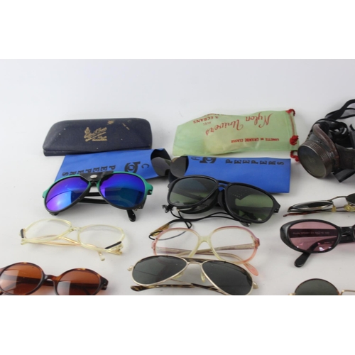 756 - A collection of assorted pairs of vintage sunglasses and spectacles to include Polaroid, 70's etc.