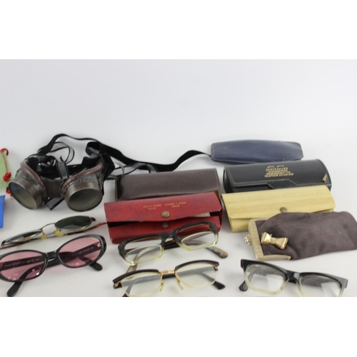 756 - A collection of assorted pairs of vintage sunglasses and spectacles to include Polaroid, 70's etc.