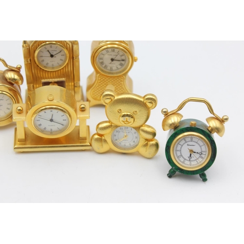 805 - Twelve assorted collectors/novelty miniature quartz clocks to include teddy bear, Cathedral etc.