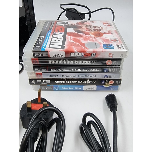 1498 - A Sony Playstation 3 with two controllers and games to include Super Street Fighter, BUZZ!, Gran Tur... 