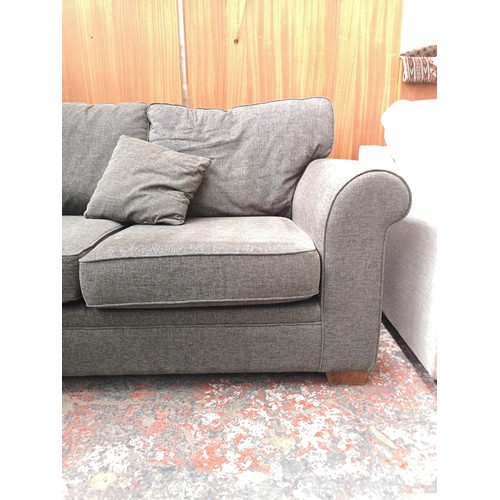 1153A - A modern grey upholstered two seater sofa with Union Jack label to reverse - approx. 89cm high x 173... 