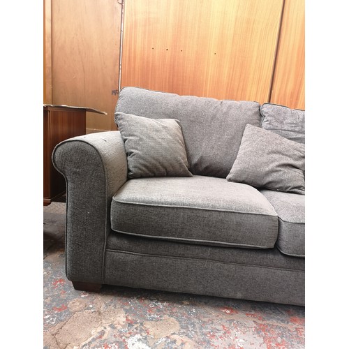 1153A - A modern grey upholstered two seater sofa with Union Jack label to reverse - approx. 89cm high x 173... 