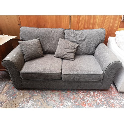 1153A - A modern grey upholstered two seater sofa with Union Jack label to reverse - approx. 89cm high x 173... 