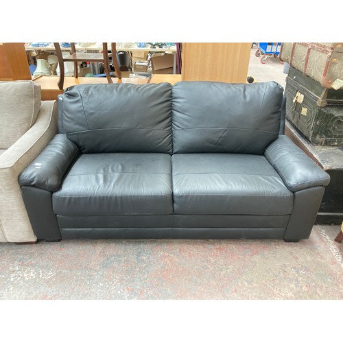 1155 - A modern black leatherette two seater sofa - approx. 85cm high x 175cm wide x 80cm deep