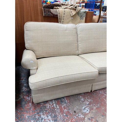 1154A - A modern cream upholstered two seater sofa