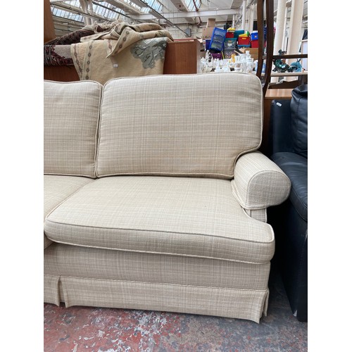 1154A - A modern cream upholstered two seater sofa